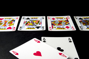 Poker, blackjack cards. Cards with chips in different situation isolated on black desk.