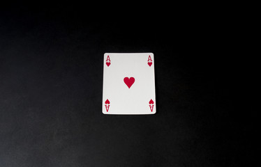 Poker, blackjack card. Ace isolated on black desk. Top view, flat lay.