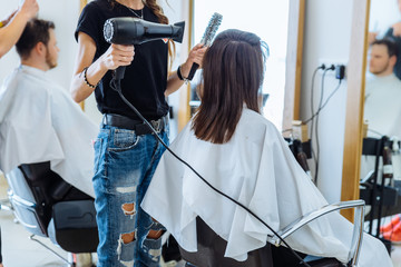 woman drying hair in hair salon