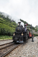Fototapeta na wymiar Alter Zug mit Dampflockomotive am Furkapass