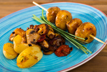 Fried shiitake, champignons and oyster mushrooms with potatoes