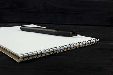 black handle on a notebook on a wooden dark background