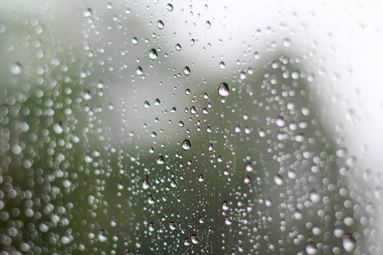 Rain drops on window glasses surface. Natural Pattern of raindrops