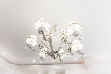 Chandelier. Fragment of the kitchen interior in a classic style in a luxury apartment.