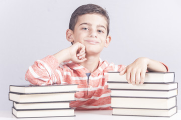 Educational concept with happy school boy posing with his books