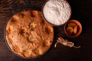 apricot pie and a bowl with flour and other ingredients and tools table
