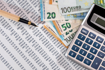 Euro banknotes with calculator and pen on bank account statement