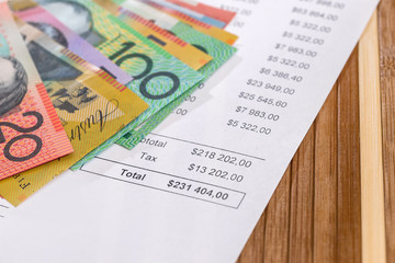 Australian dollars on purchasing order on wooden background