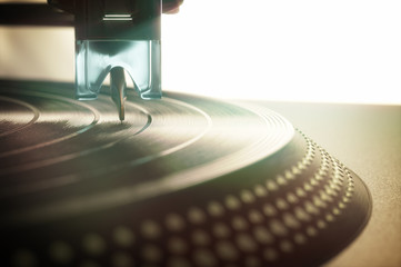 Vinyl record being played on old retro vintage disc jockey device.