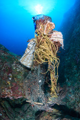 A mess of discarded plastic and fishing nets entangled on a tropical coral reef