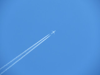 Trail of jet plane on clear blue sky. Airplane in the sky with contrail	