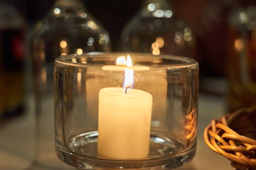 Candle on a table with blurred background bokeh.