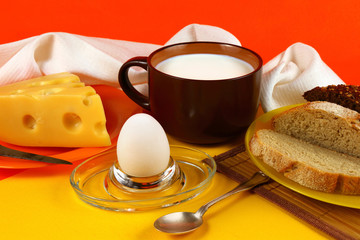 Breakfast with a mug of milk, egg and cheese