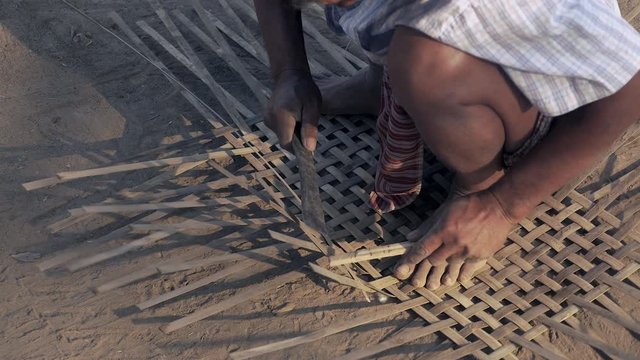 Weaving baby cradle with bamboo laths ( extreme close up)