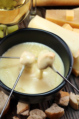 Gourmet Swiss fondue dinner on a winter evening with assorted cheese