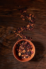 cup of tea with dried tea leaf on the wooden background. A creative vapor of dry tea