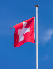 Flag of Switzerland against blue sky
