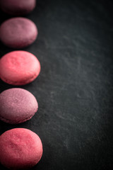 Group of macarons made of strawberries, cream, chocolate and blueberries. Rustic photo.