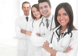 Fototapeta premium female doctor with group of happy successful colleagues