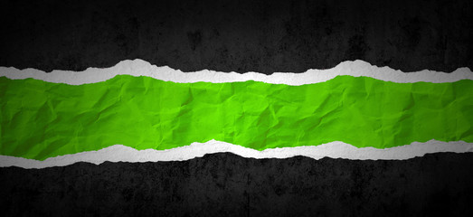 Ripped black paper on green