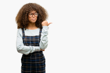 African american woman wearing a retro style pointing with hand and finger up with happy face smiling