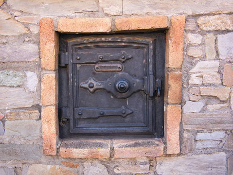 T&uuml;r von einem alten Backofen au&szlig;en an der Fassade
