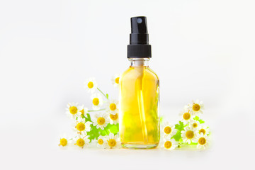 Essence of flowers on table in beautiful glass bottle