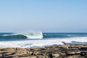 Crashing Wave on a rocky beach