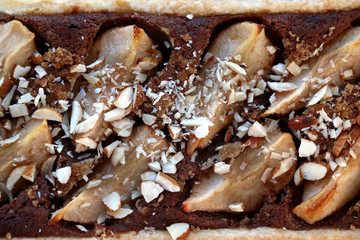 Tart with pear and almond filling and decoration. Top view, close-up.