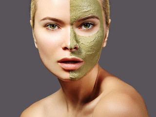 Beautiful Woman Applying Green Facial Mask. Beauty Treatments. Close-up Portrait of Spa Girl Apply...