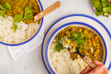 Lentil curry with rice, Indian cuisine, tarka dal, white background, top view. Vegan food.