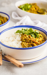 Lentil curry with rice, Indian cuisine, tarka dal, white background. Vegan food.
