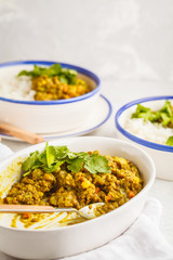 Lentil curry with rice, Indian cuisine, tarka dal, white background. Vegan food.