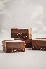 Chocolate fudge bars on white background. Raw vegan dessrt.
