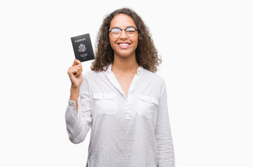 Young hispanic woman holding passport of United States of America with a happy face standing and smiling with a confident smile showing teeth