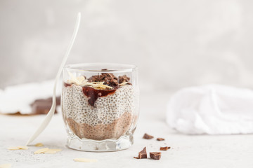 Chia pudding with chocolate, almonds and berry jam, copy space. Raw vegan dessert.