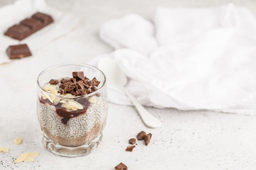 Chia pudding with chocolate, almonds and berry jam, copy space. Raw vegan dessert.