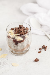 Chia pudding with chocolate, almonds and berry jam. Raw vegan dessert.