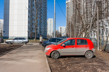 Fototapeta na wymiar Drivers parked their cars on the lawn. People are breaking parking rules. Moscow, Russia.