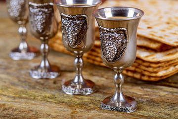 A Jewish Matzah bread with four glasses wine. Passover holiday concept