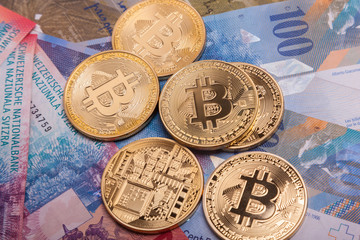 Bitcoin btc crypto currency coin over swiss francs bank notes