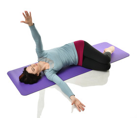 Mother woman exercising doing postnatal workout. Female fitness stretching hands and legs in gym...