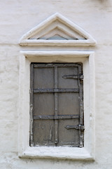 Fototapeta na wymiar Old window in the stone wall