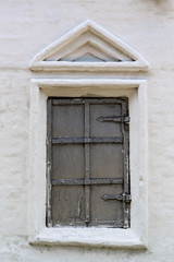 Old window in the stone wall