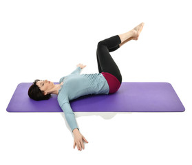 Mother woman exercising doing postnatal workout. Female fitness stretching hands and legs in gym...