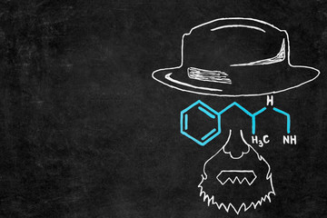 Drawn chalk man with hat and glasses as chemical formula on blackboard with copy space.