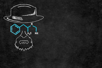 Drawn chalk man with hat and glasses as chemical formula on blackboard with copy space.