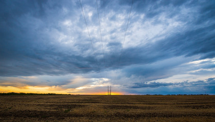 Dramatic sunset sky with clouds. Rural landscapes