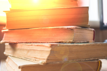 a stack of old yellowed books