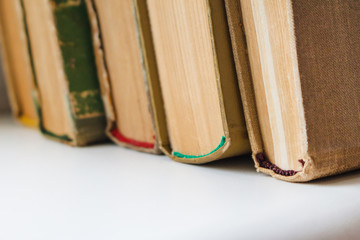 a stack of old yellowed books